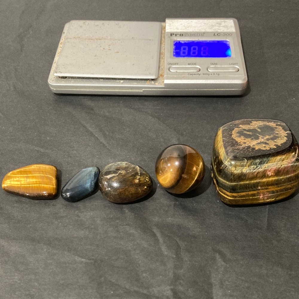 5 polished stones; 1 small blue, 2 small tiger, 1 marble, 1 large tiger